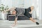 flexible athletic man in sportswear practicing side plank on yoga mat