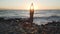 Flexible caucasian girl doing tree yoga asana at seashore at sunset.