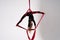 Flexible circus Artist performs on the aerial silk on white background. Concept of willpower, motivation and passion