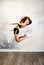 Flexible cute little girl child gymnast jumping and having fun