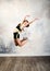 Flexible cute little girl child gymnast jumping and having fun