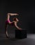 Flexible dancer training on cube in studio