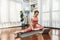 Flexible and dexterity woman in sportswear doing reverse gaiety yoga position