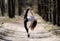 Flexible female gymnast makes exercise in the forest. Concept of a balance