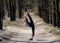 Flexible female gymnast makes exercise in the forest. Healthy lifestyle