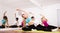 Flexible girls practice yoga in in fitness center