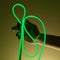 Flexible green led tape neon in hand on black background