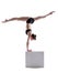 Flexible gymnast balancing on cube in studio