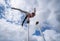 Flexible male circus Artist keep balance by one hand against amazing cloudscape. Individuality, outstanding and