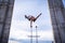 Flexible male circus Artist keep balance by one hand in the concrete structure. Individuality, outstanding and