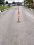 flexible orange PVC delineator post instored on the road for traffic sign gears