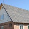 Flexible shingles of bitumen roofing surface on the brick house