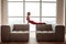 Flexible short-haired young woman stretching her body during yoga session