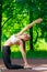 Flexible slim girl doing yoga in the park