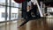 Flexible sportswoman is having a stretching training in fly yoga gym.