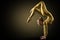 Flexible Woman Gymnast doing Yoga Stretching Pose. Standing on hands Back bending. Gold perfect strong healthy Acrobat Body
