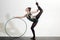 Flexible woman in sport pose with hula hoop. flexible body of athlete woman with gymnastic ring.