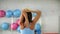 Flexible woman stretching hand in fitness club rear view. Back view fitness woman training stretching exercise for hand