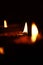 Flickering candles lit in a dark church, providing a warm and inviting atmosphere