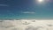 Flies through fluffy clouds in morning at sun. Wide footage