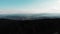 Flight above pine tree forest at sunset. Flying above mountains. Incredible view of carpathian mountains. Aerial drone view of gre