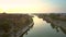 Flight above river bridge in Hoian at dawn