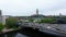 Flight above water surface of Havel river, fly over road bridge and reveal train station near Rathaus Spandau. Old city