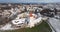 flight and aerial winter panoramic view overlooking the old city and historic buildings of medieval castle with snow