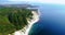 Flight along the rocky coast of the sea and near the resort of Gelendzhik, Black sea. High layered rocks covered with