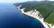 Flight along the rocky coast of the sea and near the resort of Gelendzhik, Black sea. High layered rocks covered with