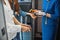 Flight attendant checking passengers temperature with non-contact thermometer