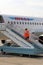 Flight attendant is on the ladder at the airport in Tyumen