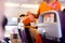 Flight attendant serving drinks to passengers on board.