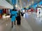 The flight attendants walking and bringing their own black colored suitcase at Soekarno - Hatta terminal