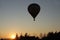 Flight in a balloon in the rays of the evening sunset. Hot air fills the sphere and raises it up. Adventure travel by air on an