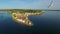 Flight with birds over old city Piran, aerial panoramic view with roofs, St. George\'s Parish Church, fortress and the sea.