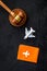 Flight cancellation. Airplane, passport, judge gavel on black desk top-down