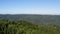 Flight from a canopy over a vast mountain terrain