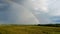 Flight Down Ripe Crop Field After Rain and Colorfull Rainbow in Background Rural Countryside