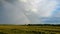 Flight Down Ripe Crop Field After Rain and Colorfull Rainbow in Background Rural Countryside