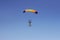 Flight of an experienced paratrooper with a professional parachute in the sky