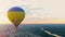 Flight on hot air balloon towards sunset above city, holiday entertainment
