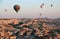 Flight of hot air balloons at dawn over a valley in Cappadocia near the town of Goreme