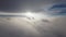 The flight is like a dream. Aerial view low flight over fluffy clouds at sunset towards the sun. Aeronautics in the