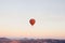 Flight of a lonely balloon in the sky in the morning at sunrise or in the evening at sunset. Travel by air or adventure