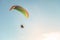 Flight on a motorized glider in the blue sky with bright backlight sunlight