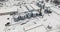 flight over agro silos granary elevator in winter day in snowy field. Silos on agro-processing manufacturing plant