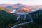 Flight over the autumn mountains with mountain road serpentine