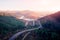 Flight over the autumn mountains with mountain road serpentine