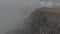 Flight over the cliffs of the edge of the plateau in the northern Caucasus. The boundary of the cloud on the precipice